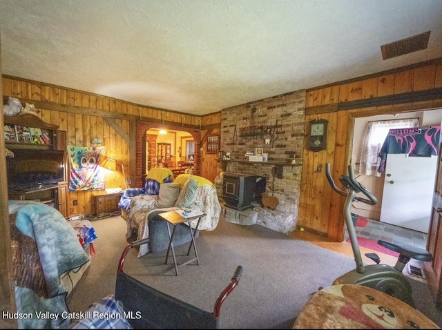 125 County Route 26a, Stuyvesant, NY 12106 - carpeted living area featuring wood walls, arched walkways, and a textured ceiling