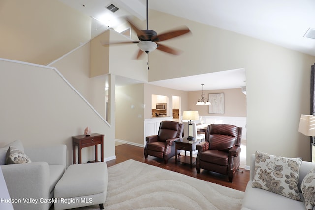living room with high vaulted ceiling, a ceiling fan, visible vents, stairway, and wood finished floors