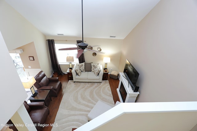 living room with wood finished floors, ceiling fan, and visible vents