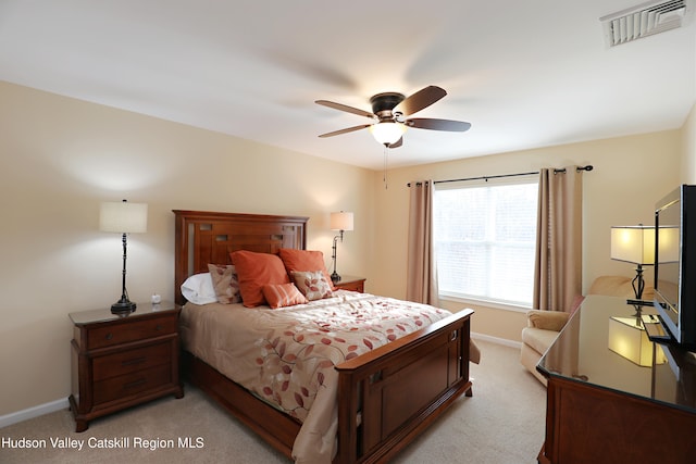 bedroom with ceiling fan, light colored carpet, baseboards, and visible vents