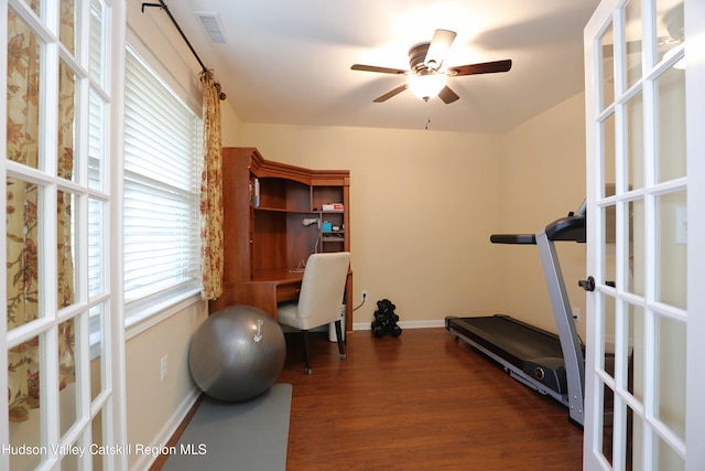 exercise room featuring baseboards, french doors, visible vents, ceiling fan, and wood finished floors