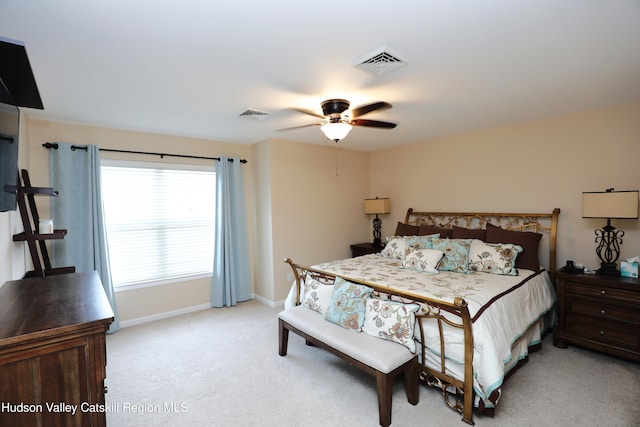 bedroom featuring light carpet, ceiling fan, baseboards, and visible vents