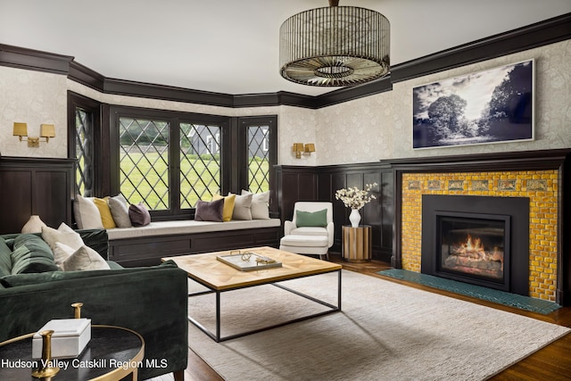 9 Chambers Rd, West Park, NY 12493 - living room featuring a fireplace with flush hearth, a wainscoted wall, crown molding, wood finished floors, and a decorative wall