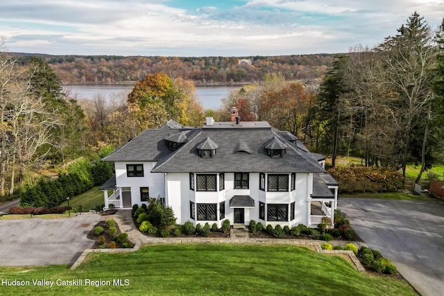 9 Chambers Rd, West Park, NY 12493 - view of front facade featuring stucco siding, a water view, a shingled roof, a view of trees, and a front yard