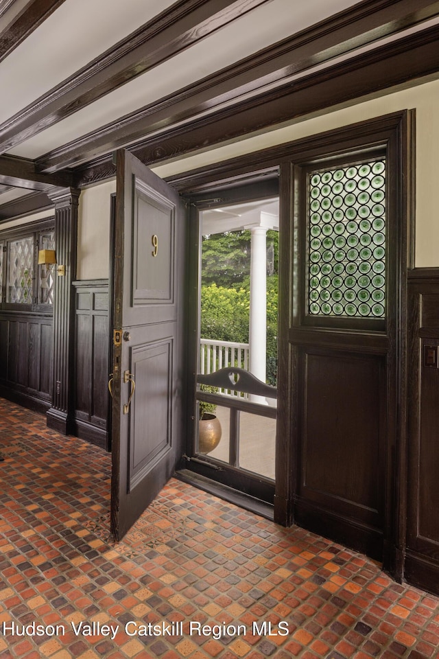 9 Chambers Rd, West Park, NY 12493 - entryway featuring brick patterned flooring, decorative columns, and a wainscoted wall