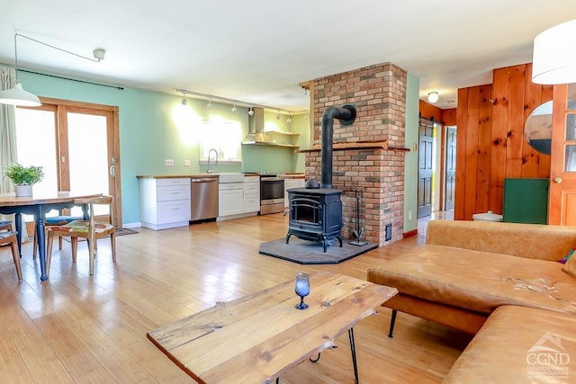 32 Harvey Mountain Rd, Austerlitz, NY 12017 - living room featuring a wood stove and light wood-style floors