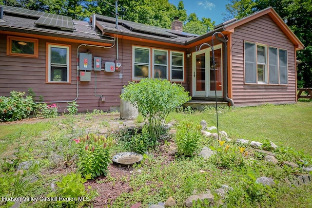 32 Harvey Mountain Rd, Austerlitz, NY 12017 - view of front of property featuring roof mounted solar panels, a chimney, and a front yard