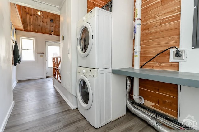 32 Harvey Mountain Rd, Austerlitz, NY 12017 - washroom featuring stacked washer and clothes dryer, baseboards, and wood finished floors