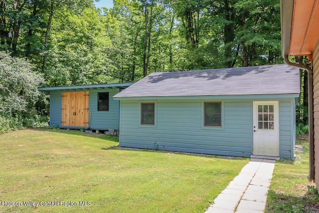 32 Harvey Mountain Rd, Austerlitz, NY 12017 - rear view of property with an outdoor structure, a yard, and roof with shingles