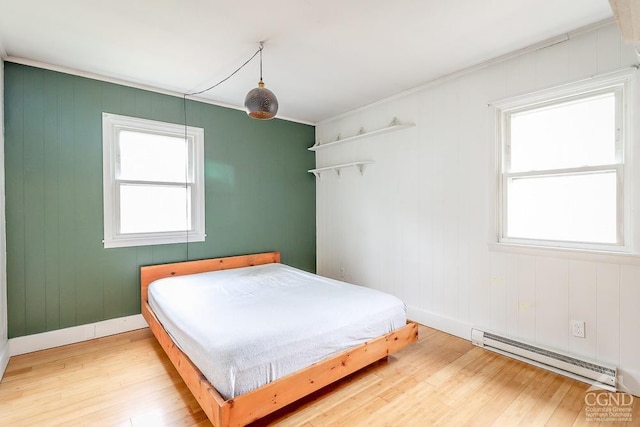 32 Harvey Mountain Rd, Austerlitz, NY 12017 - bedroom featuring baseboard heating, wood finished floors, multiple windows, baseboards, and crown molding