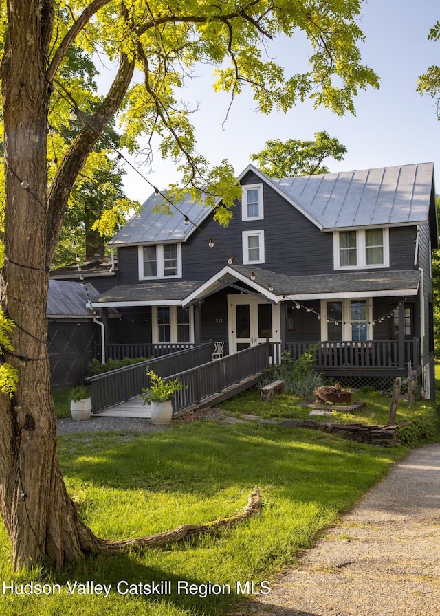 222 Main St, Germantown, NY 12526 - farmhouse inspired home featuring covered porch, a front yard, a standing seam roof, and metal roof