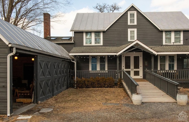 222 Main St, Germantown, NY 12526 - view of front of house featuring a porch, metal roof, a chimney, and a standing seam roof