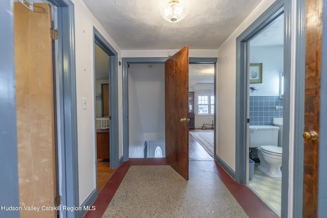 2236 Ny 385, Coxsackie, NY 12051 - hall with wainscoting, baseboards, tile walls, and a textured ceiling