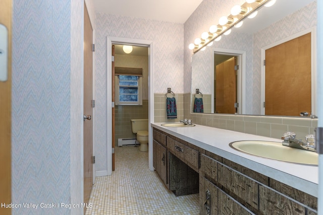 bathroom featuring toilet, vanity, a baseboard radiator, and tile patterned floors