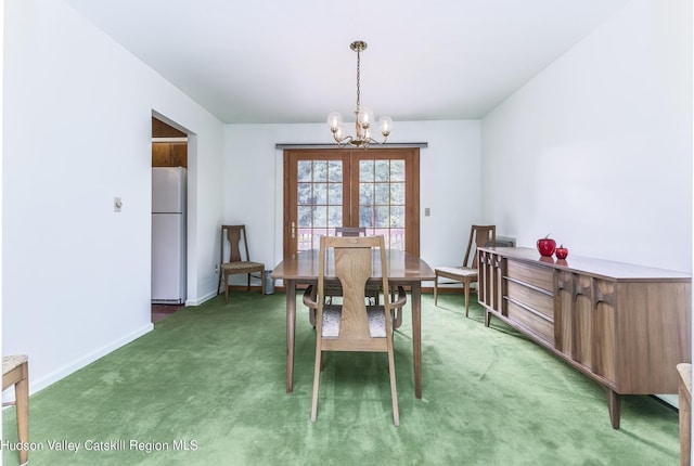 carpeted dining space featuring an inviting chandelier