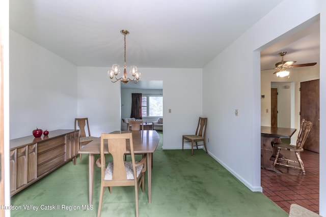 carpeted dining room featuring ceiling fan with notable chandelier