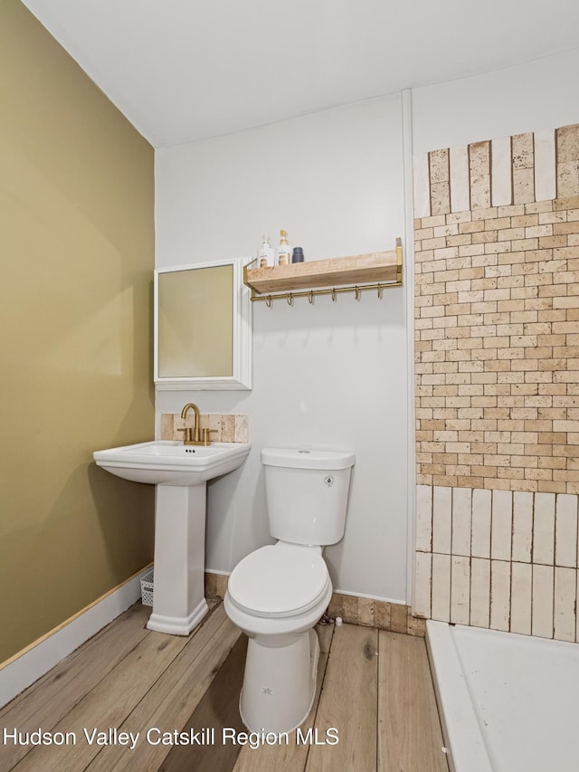 397 Main St, Franklin, NY 13775 - full bathroom featuring wood finished floors, toilet, and baseboards