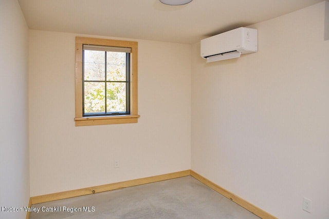spare room with baseboards and a wall unit AC
