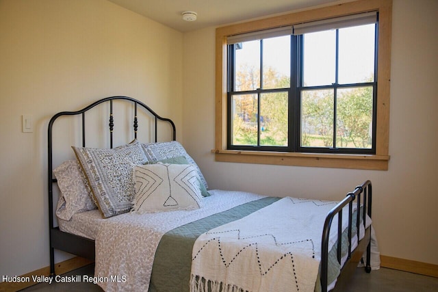 bedroom featuring baseboards and wood finished floors