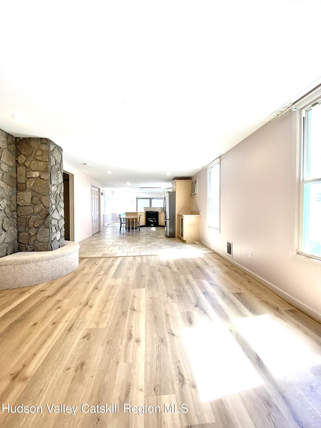 88 Grand St, Kingston, NY 12401 - unfurnished living room with light wood finished floors and baseboards