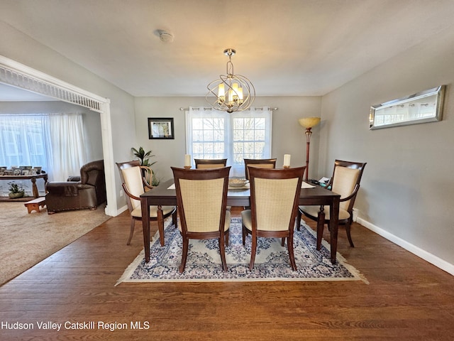 dining room featuring an inviting chandelier and dark hardwood / wood-style floors