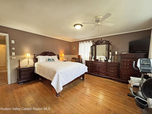 bedroom featuring crown molding and light hardwood / wood-style flooring