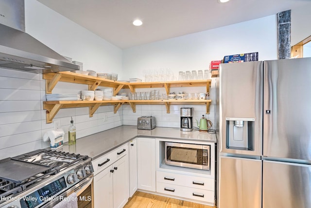 158 Rivka Rd, Saugerties, NY 12477 - kitchen featuring open shelves, appliances with stainless steel finishes, decorative backsplash, and wall chimney exhaust hood