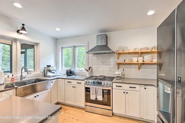 158 Rivka Rd, Saugerties, NY 12477 - kitchen featuring wall chimney range hood, backsplash, a sink, light wood finished floors, and stainless steel appliances