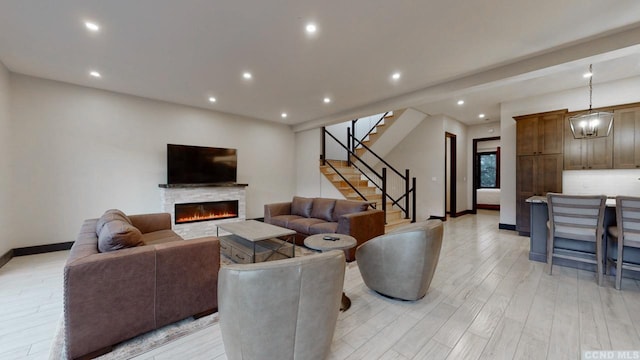 292 S St Unit 2, Windham, NY 12496 - living room featuring a glass covered fireplace, stairway, recessed lighting, baseboards, and light wood finished floors