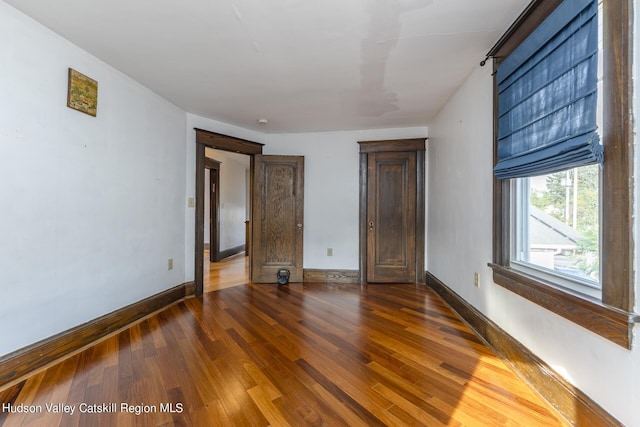 unfurnished bedroom with dark hardwood / wood-style flooring