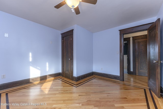 spare room with light hardwood / wood-style floors and ceiling fan