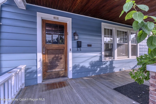 view of exterior entry featuring a porch