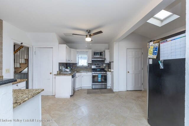 kitchen featuring white cabinetry, ceiling fan, light stone countertops, tasteful backsplash, and appliances with stainless steel finishes