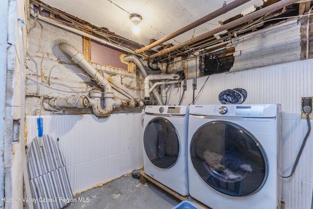 clothes washing area with washing machine and dryer