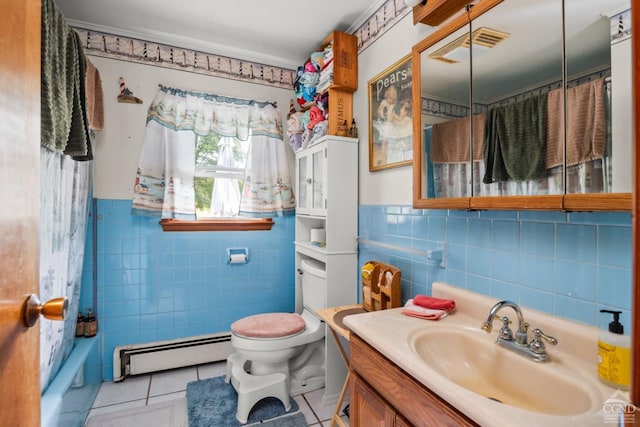 bathroom with a baseboard heating unit, tile patterned floors, tile walls, toilet, and vanity