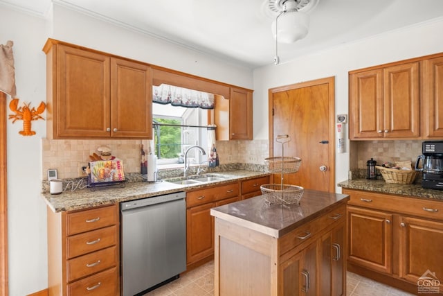 kitchen featuring dishwasher, a sink, backsplash, a kitchen island, and ornamental molding