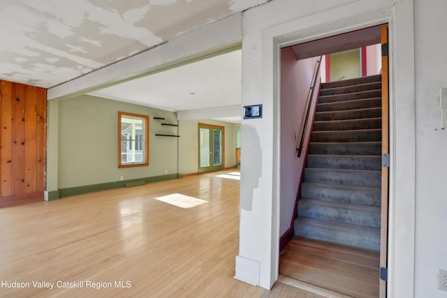 staircase with hardwood / wood-style flooring