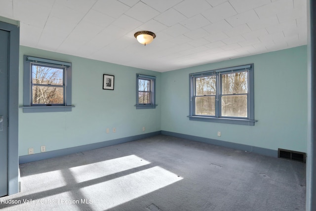 unfurnished room featuring light carpet