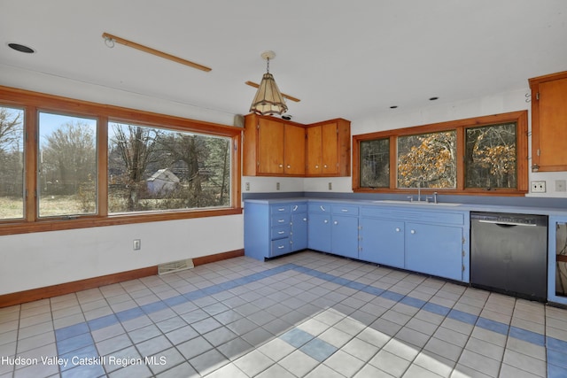 kitchen featuring dishwasher, pendant lighting, light tile patterned flooring, and sink