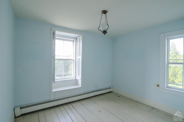 bonus room featuring a baseboard heating unit and healthy amount of natural light