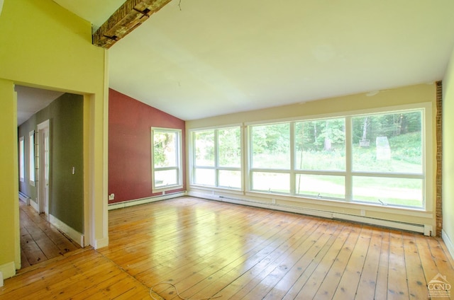 unfurnished living room with vaulted ceiling, a baseboard radiator, light wood-style flooring, and baseboards