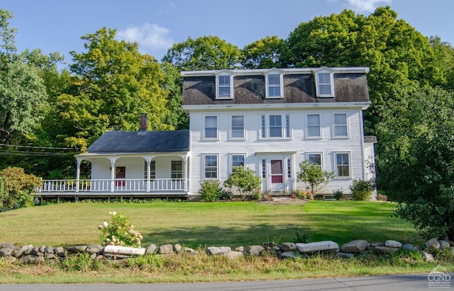 view of front of property with a porch, a front yard, a shingled roof, and mansard roof