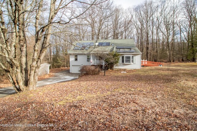 view of front of house featuring solar panels and a garage