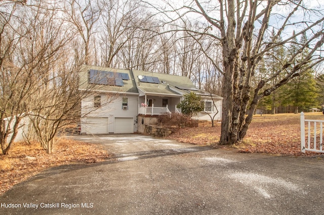 view of front of home featuring a garage and solar panels