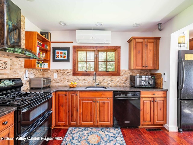 12 Library Ln, Woodstock, NY 12498 - kitchen with black appliances, a wall unit AC, ventilation hood, dark wood-style floors, and brown cabinets