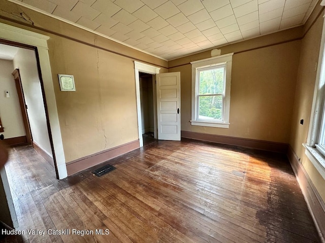 unfurnished bedroom featuring dark hardwood / wood-style flooring