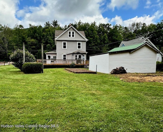 back of house with a yard and a deck