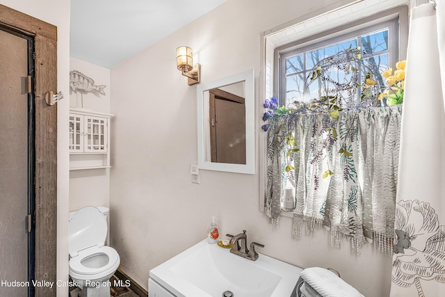 bathroom featuring vanity and toilet