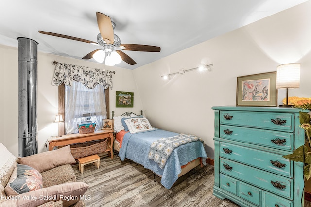 bedroom featuring dark hardwood / wood-style floors, vaulted ceiling, and ceiling fan