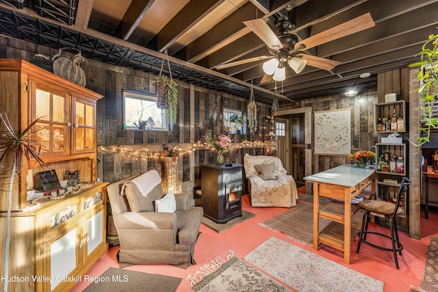 living area with wood walls and ceiling fan